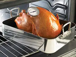 Oven-safe probe thermometer inserted into a turkey