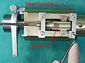1. Remove the four screws fastening the two bearing blocks to the cylinder. Then lift off the bearing blocks with pinion and flexible shaft.