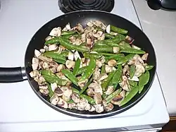 3. Add mushrooms and sugar snap peas. Fry on medium heat.