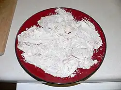 4. While mushrooms and peas are frying, flour the chicken.