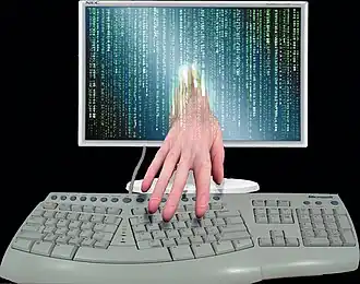 A hand reaching out of a monitor.