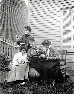 Group of four women eating outdoors