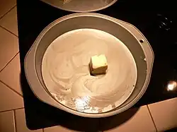 Melt the butter in the cake pan