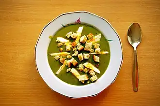 Sorrel soup topped with croutons