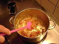 2. mixing in tomato paste, sugar, and Hungarian pepper