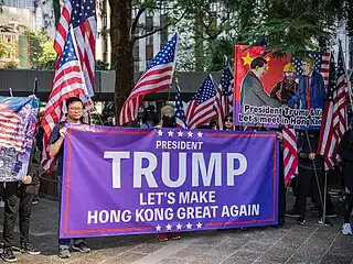 Protesters holding a sign saying "Let's make Hong Kong great again"