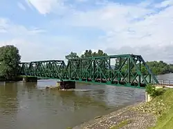 Side view of the iron truss railway bridge over Mura River in Mursko Središće, Croatia