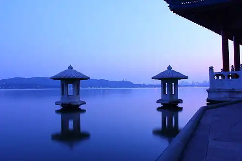 Night view of a lake with a pavilion