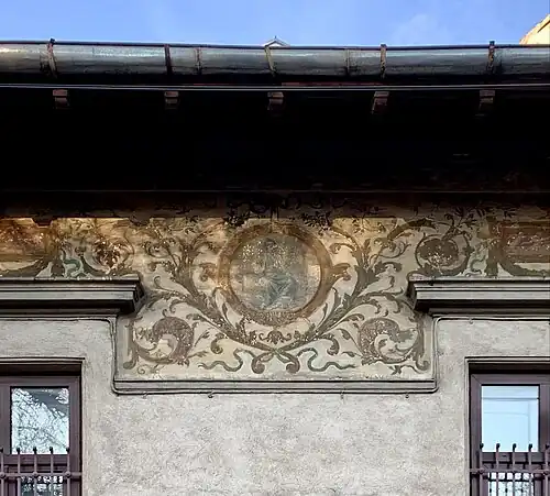 Fresco with cartouches and foliage spirals on the upper part of the facade of Strada Occidentului no. 11, Bucharest, painter: C. Cora, architect: Cesare Fantoli, 1910[57]