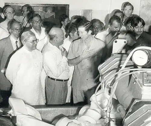Black and white photograph of Charles in Gujarat with a crowd of people