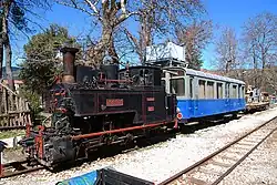 Cail narrow gauge (750&nbsp;mm) steam locomotive ΔΚ-8001 and observation car ΑΒ ΔΚ-121 of the Diakofto-Kalavryta rack railway .