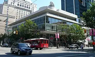 A glass-faced office building on a street corner