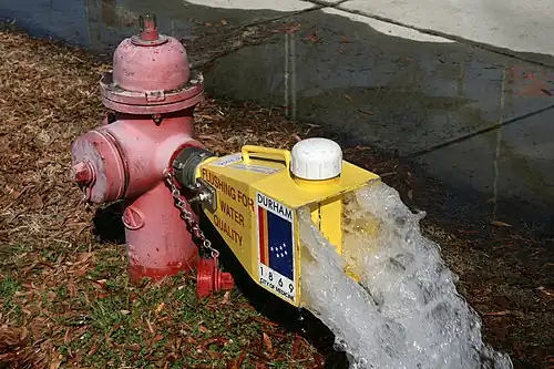 A fire hydrant flushing water through a diffuser in Durham, North Carolina