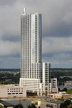 Photograph of a skyscraper that suddenly narrows asymmetrically about half-way to the top
