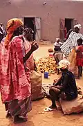Women with children and cassava roots at Sangha market, 1992