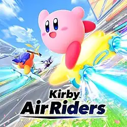 Kirby—a round, pink character—rides his Warp Star—a yellow star-shaped aircraft—with electronic motors in front of a grass background and to the right of the game logo. Other characters are riding separate machines in the background.