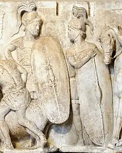 A monochrome relief stele depicting two figures dressed as Roman legionaries