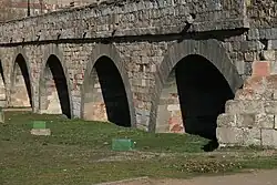 Arches of the bridge built in medieval times on the side of the river opposite the original city