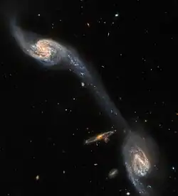This image from the NASA/ESA Hubble Space Telescope shows two of the galaxies in the galactic triplet Arp 248. [20]