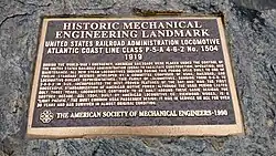 A commemorative plaque mounted on a stone