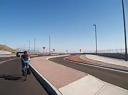 Cyclist rides through the main lane of roundabout