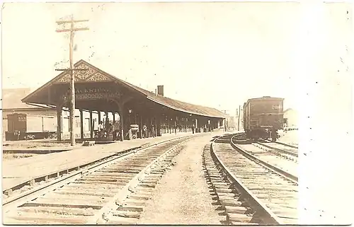 A black-and-white postcard of a small railway station