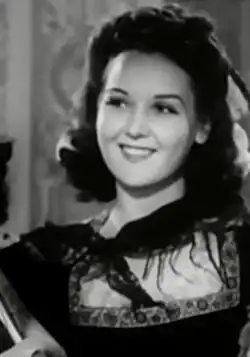 A young white woman with dark curly hair