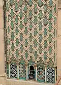 Zellij on the minaret of the Bou Inania Madrasa in Fez (14th century), with mosaic panels below and green sgraffito tiles above