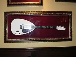 A white teardrop shaped guitar as used by Brian Jones, on display at the Hard Rock Cafe in Sacramento, California