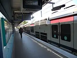 Train stopping on its way to Noisy-le-Grand. The noticeboard indicates what stations the train will stop at and the screen indicates the following trains (time and destination)