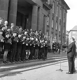 An English choir wearing their school caps in 1963