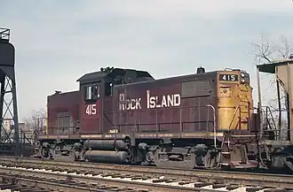 Reddish-brown locomotive with cab located in the middle