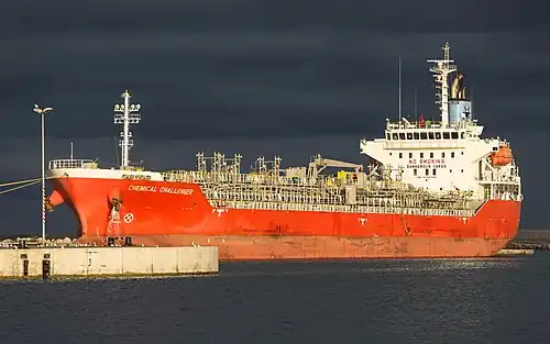Chemical Challenger moored in the harbour of Sète, Hérault, France. A ship is a large watercraft that travels the world's oceans and other sufficiently deep waterways.