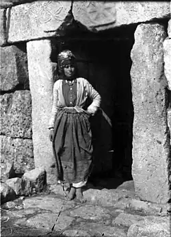 Kurdish girl standing in doorway.