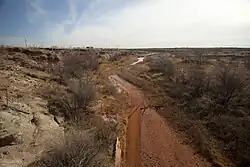 The Colorado River 5&nbsp;mi (8&nbsp;km) from its source along the Caprock Escarpment, the border of Dawson and Borden County.