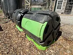 Compost rollers are used to cleanly produce rich, organic compost for sustainable gardens.  Food waste, veggie scraps, grass clippings, cardboard, biochar, leaves and other biomass are mixed together.  These inputs have varying levels of carbon and nitrogen which are required for producing compost.  Microbes and insects break down these inputs into a rich soil amendment to help fertilize plants sustainably.