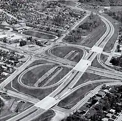 An aerial view of a freeway interchange, in black and white