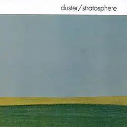Muted blue-grey sky over a golden-yellow horizon and dark green ground, with the white text "duster/stratosphere" in the upper right corner.