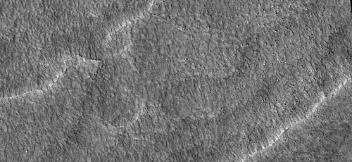 Close up of scalloped ground, as seen by HiRISE under HiWish program. Surface is divided into polygons; these forms are common where ground freezes and thaws. Note: this is an enlargement of a previous image.