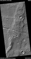 Trough cutting a wrinkle ridge, as seen by HiRISE under HiWish program. Location in the Coprates quadrangle, Mars.