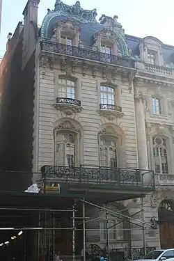 The facade seen from across 72nd Street. The facade is four stories high, including the roof. The entrance is on the left side of the ground or first floor, and there is a balcony on the second floor.