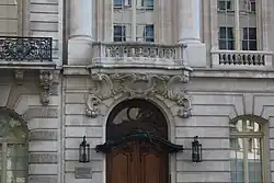 The entrance to the house, an arched doorway with decorations above it