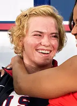 Headshot of a smiling Pirozhkova with Michelle Obama visible on the right edge of the photo
