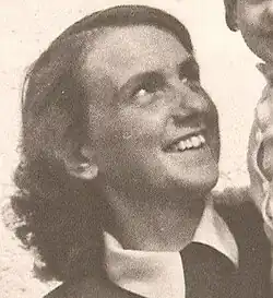 Sepia three-quarter profile Press shot of a laughing young woman with long hair, looking upwards