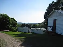 Elk Mountain viewed from the nameless hill above Elkview, with camp buildings in the foreground.