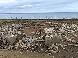 The excavated remains of the large roundhouse in Dinas Dinlle hillfort in 2022