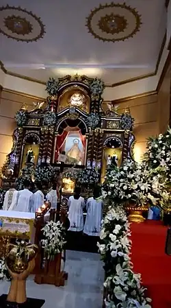 Our Lady of Aránzazu being enthroned on her retablo at the high altar of the church