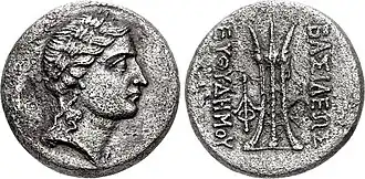 Cupro-nickel coin of Euthydemus II, c. 185-180 BC with Laureate head of Apollo, and Tripod on the reverse.