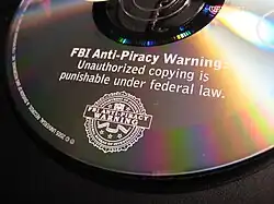 A DVD embossed with the FBI Anti-Piracy Warning, incorporating a modified FBI seal