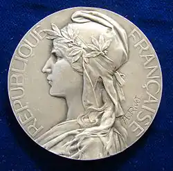 Color photograph of a medal.